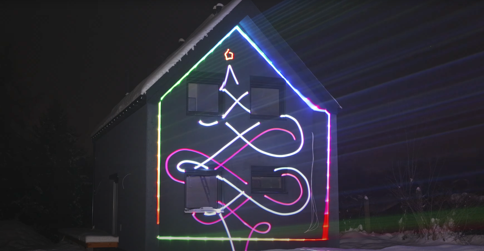 House lit up by a Christmas Light Laser Projector showing Christmas laser show effects